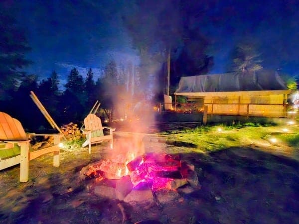 Safari tent with glowing firepit at night, Watson’s Lakefront Resort, Cataldo, Idaho