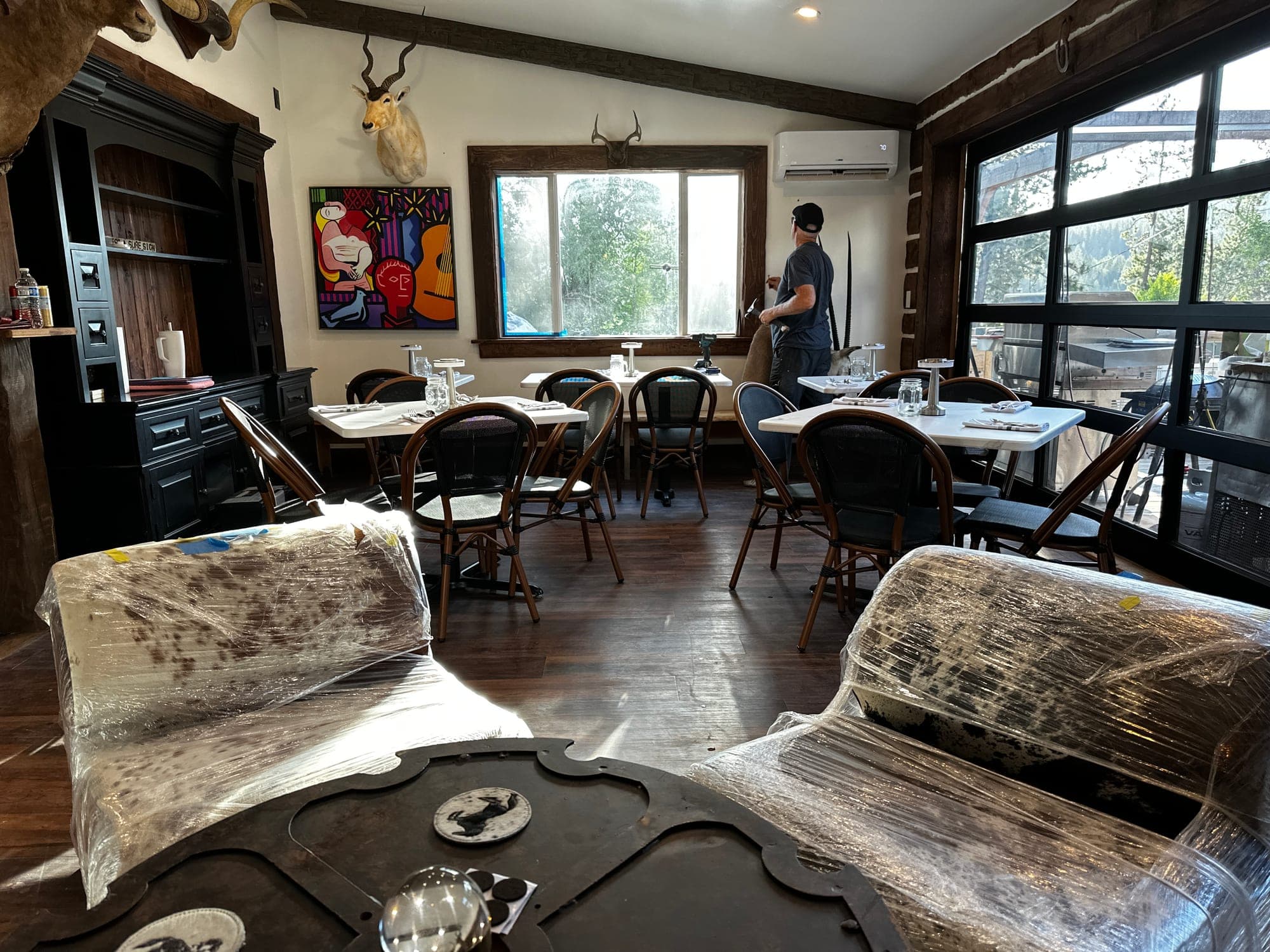 Warm leather lodge couch under a buffalo mount on the Red’s Tavern porch — the reward after a Trail of the Coeur d’Alenes ride