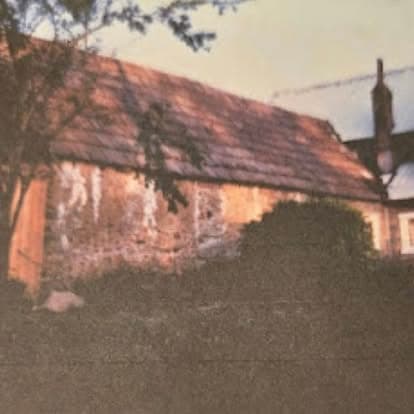 Vintage photograph of an ivy and vine-covered outbuilding on the Watson's property