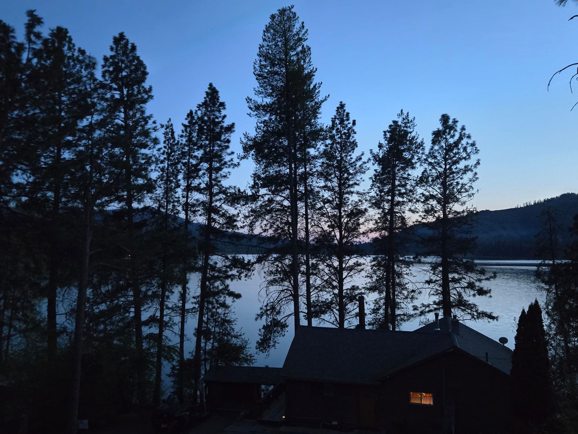 Blue-hour silhouette of Red's Tavern over Rose Lake at Watson's Lakefront Resort, Cataldo, Idaho