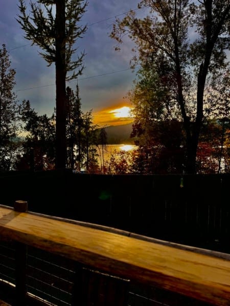 Golden-hour view from the deck railing at Watson's Lakefront Resort — a natural ceremony backdrop